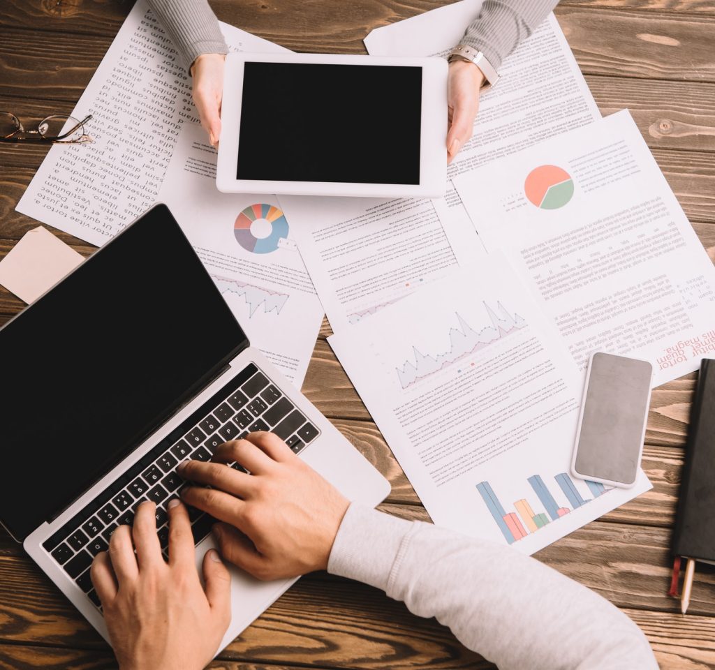 top-view-of-businesspeople-working-with-digital-devices-and-documents.jpg